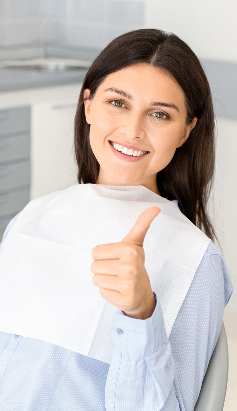 The image shows a modern dental or medical office interior with a dental chair, equipment, and a clean, professional environment.