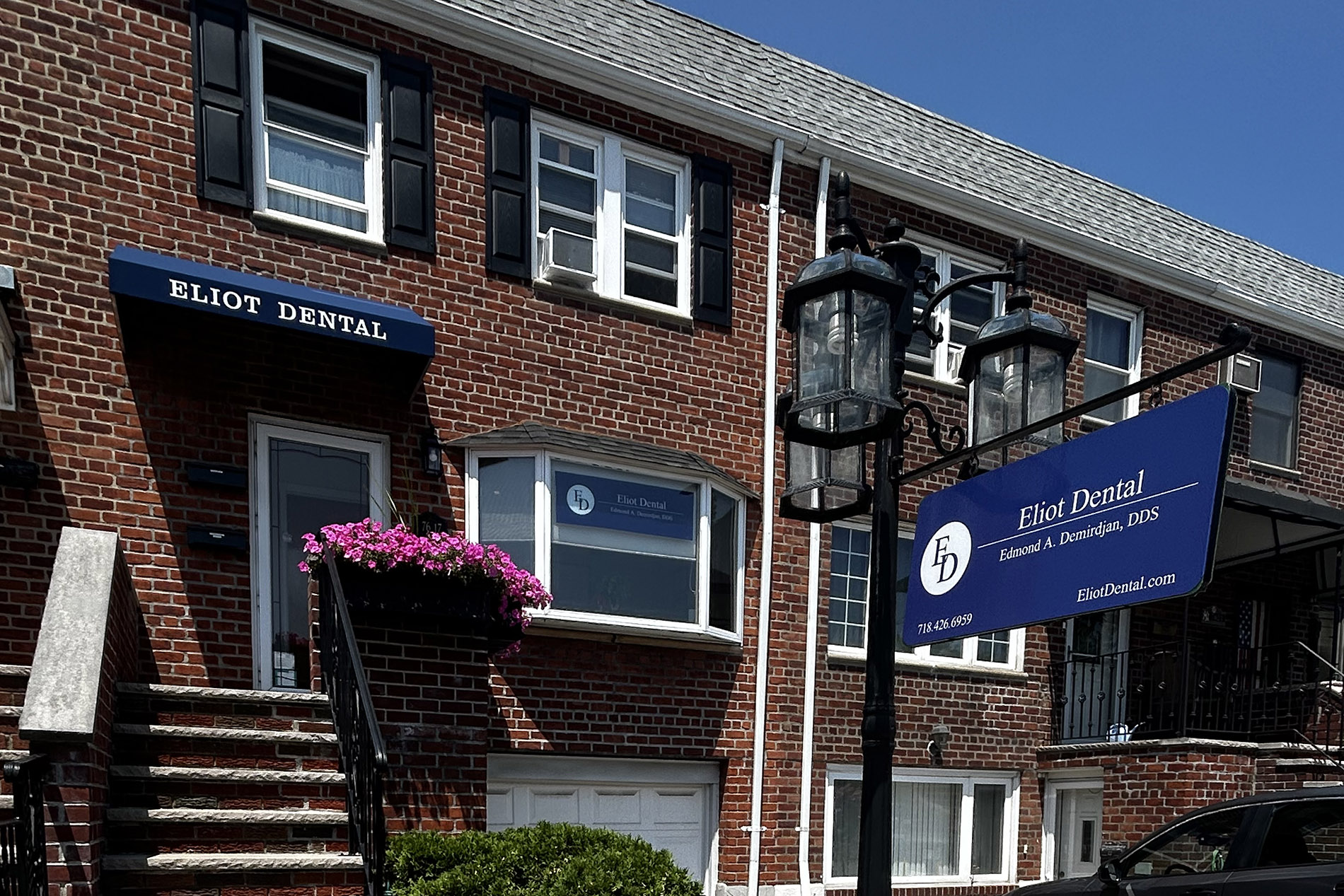 The image shows a brick building with a sign reading  Pilot Dental,  indicating it s a dental office, located on a street corner with a clear blue sky above.